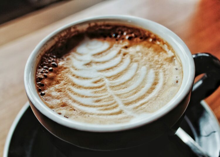 white ceramic mug with brown and white liquid