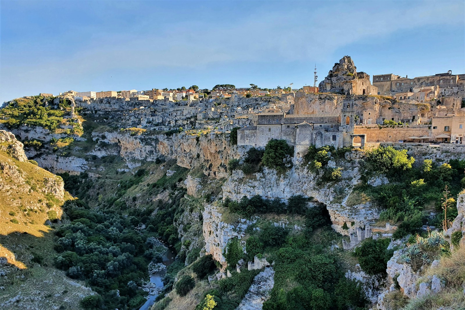a view of a village on top of a cliff