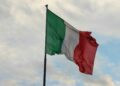 a couple of flags on a flagpole