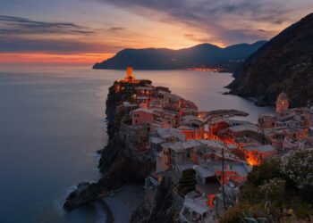 aerial view of village on mountain cliff during orange sunset