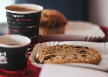 shallow focus photography of cookie and cup of coffee