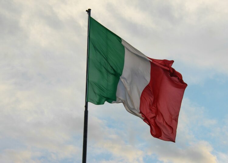a couple of flags on a flagpole