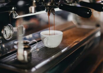 white ceramic cup on brown wooden table