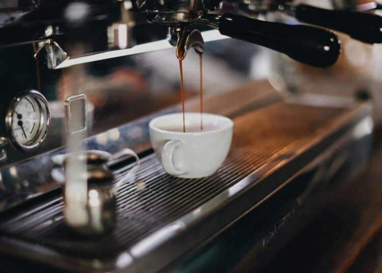 white ceramic cup on brown wooden table