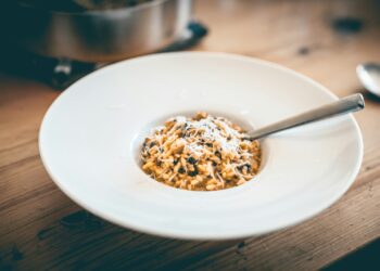 a bowl of food on a wooden table