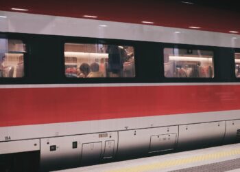 group of people inside red and gray train