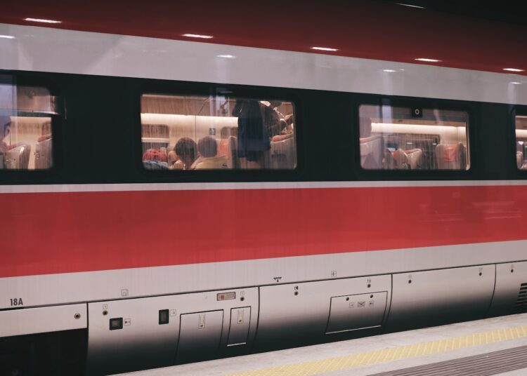 group of people inside red and gray train