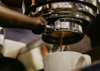 white ceramic mug under espresso maker
