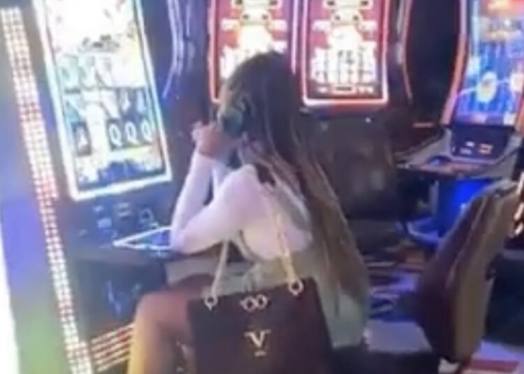 Vrouw laat zich gaan op gokstoel in casino