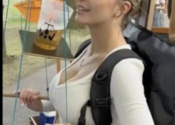 Jongedame met grote bos voor de deur denkt even een biertje te temmen met een biermarionet